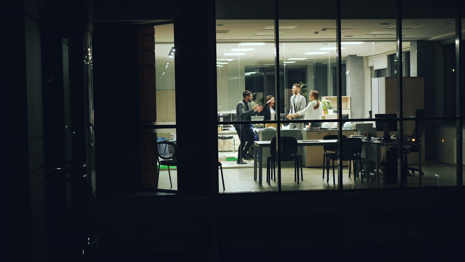 A modern office at night seen through large windows